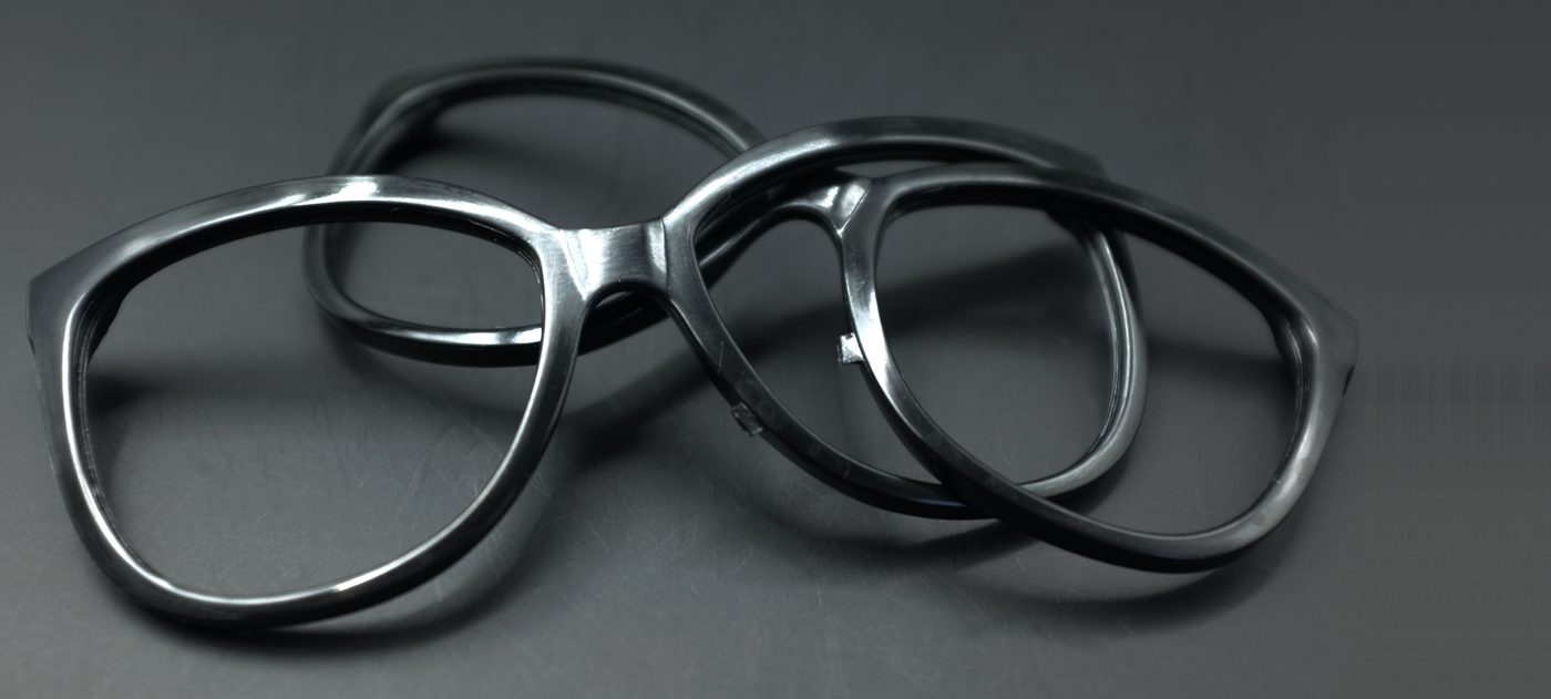 Real polished black plastic eyeglass frames showing smooth glossy surface finish